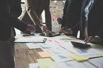 Team Business people are analyzing and brainstorming, using calculator, hands pointing financial data on a sheet, Team work process concept.