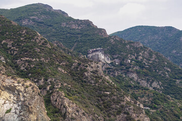 Scenic view from boat on Simonopetra Monastery (Simonos Petra) at Mount Athos, Chalkidiki, Central Macedonia, Greece, Europe. Eastern Orthodox terrain of Again Oros. Landmark build on rock formation