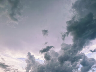 A piece of a blue sky with many clouds around. Midday cloudscape in the summer sky.