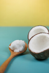 slice of fresh coconut and bottle of oil on a table 