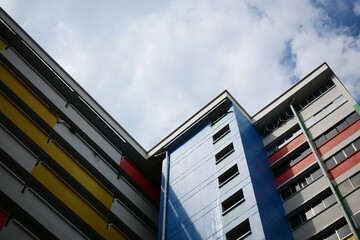 low angle view of signapore residential buildings against blue sky 