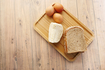 top view of cheese, egg and brown bread in a food tray 