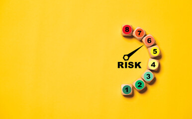 Risk level indicator rating print screen wooden cube block since low to high on yellow background for Risk management and assessment concept.