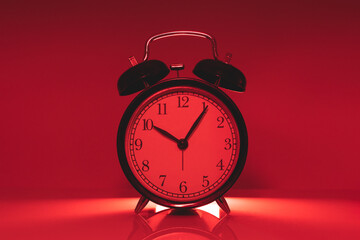 Analog time clock on red light color for times up hurry warning dangerous hours concept
