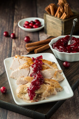 Roasted turkey slices covered with homemade cranberry sauce.