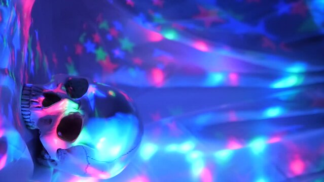Halloween concept, Skull with colored lighting loop, Vertical video theme on a flashy background