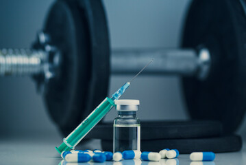 dumbbells, syringe with needle, pills and vial with steroids. illegal doping in sport concept. new years resolutions - obrazy, fototapety, plakaty