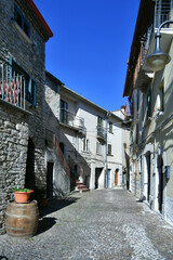 A narrow street between the old stone houses of Frosolone, a medieval village in the Molise region of Italy.