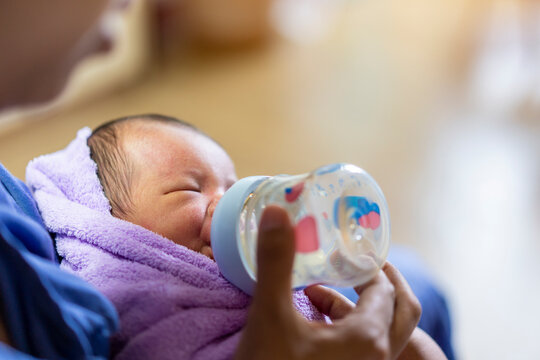 Asian baby drinking from baby bottle.,Newborn baby girl. Portrait of mom and breastfeeding baby. the best start in life