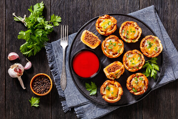 sloppy joe cups on black plate, top view