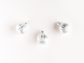 Stylish Christmas composition of silver balls on a pink background