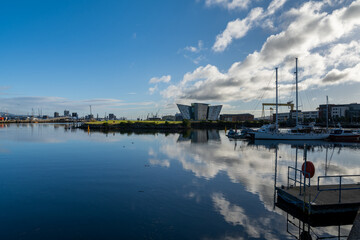 boats moored in the harbor in the Titanic Quarter of Belfast on the River Lagan with the Titanic Museum in the background