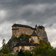 view of the medieval Orava Castle under an overcast stormy sky