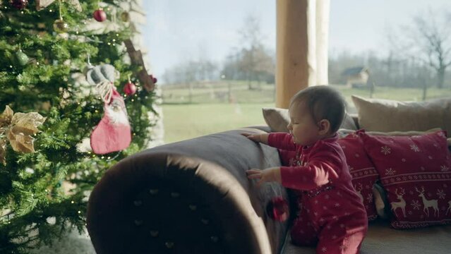 Christmas - 8m old baby playing with Christmas ornament in a beautiful cottage 