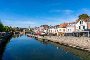 Fototapeta na wymiar the canals of the Somme River and the historic old city center of Amiens under a blue sky