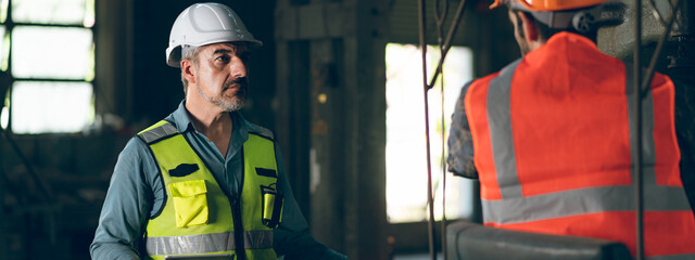industrial factory with men at work concept, professional engineer foreman inspector talking in...