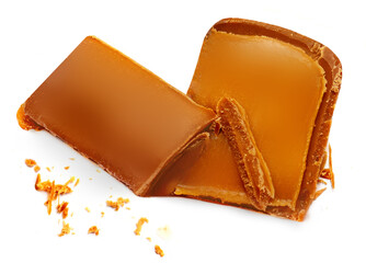 Creative layout made of Caramel candies with caramel sauce isolated on a white background Flat lay. Food concept.