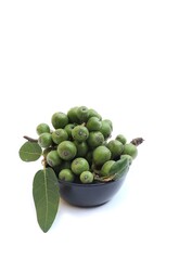 Closeup of Raw  Fig Fruit with Leaves in a Black Bowl Isolated on White Background in Vertical Orientation