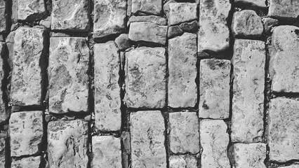 Monochrome Brick Wall Background. Shabby Brickwork Facade with Old Damaged Surface. Grunge Stone wall backdrop. Horizontal Black and white Banner