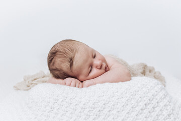 portrait of a sleeping baby wrapped in a cloth - obrazy, fototapety, plakaty