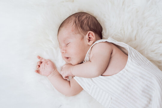 portrait of a sleeping baby lying on a fur