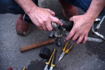 Male hands of a car mechanic with tools in outdoor work