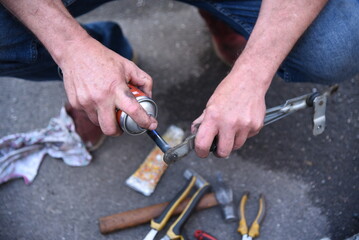 Male hands of a car mechanic with tools in outdoor work