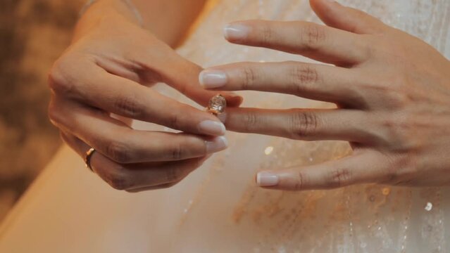 marriage hands with rings. Engagement, marriage and wedding concept. Ring wedding. Close-up slim female Caucasian young hands touching engagement ring on finger. Solitaire diamond ring in women hand