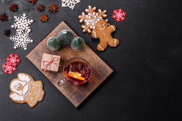 Christmas mulled red wine with spices and fruits on a concrete table