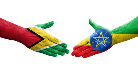 Handshake between Ethiopia and Guyana flags painted on hands, isolated transparent image.