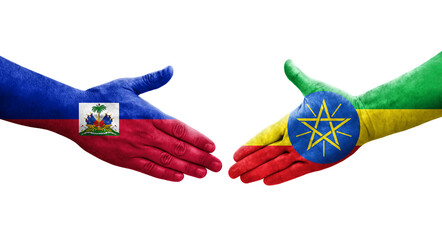 Handshake between Ethiopia and Haiti flags painted on hands, isolated transparent image.