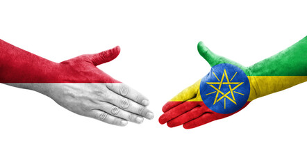 Handshake between Ethiopia and Monaco flags painted on hands, isolated transparent image.