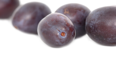 Ripe plum berries isolated on white background.