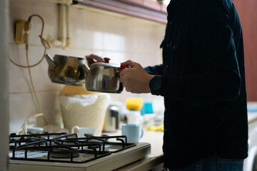 person in the kitchen makeing turkish tea