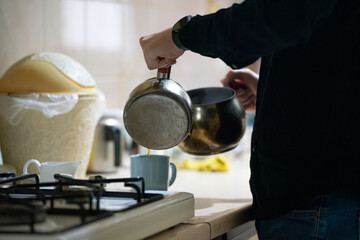 person in the kitchen makeing turkish tea