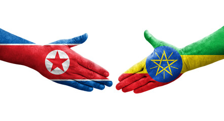 Handshake between Ethiopia and North Korea flags painted on hands, isolated transparent image.