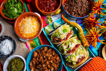 Tacos with all the Trimmings like chicken, Beef, Sour Cream and Cheese on a Rustic Background to be Served in a Restaurant 