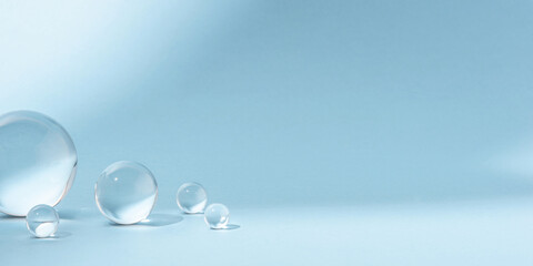Fototapeta na wymiar Blue background with transparent glass balls. Minimal concept and soft sunlight.