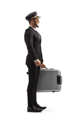 Full length profile shot of a pilot in a uniform standing and holding a suitcase © Ljupco Smokovski