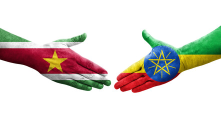 Handshake between Ethiopia and Suriname flags painted on hands, isolated transparent image.