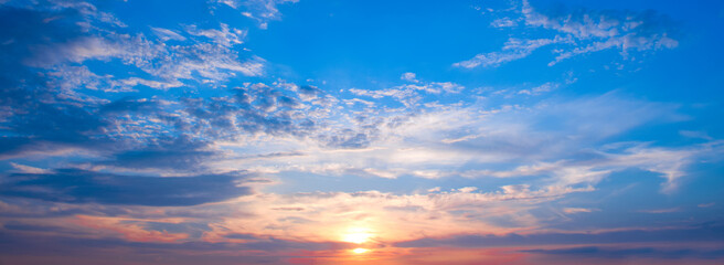 Beautiful sky with bright sunrise and light clouds. Wide format.