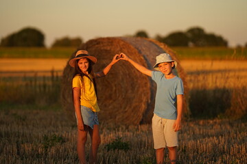 Children against war. Russia's invasion of Ukraine, request for help from world community. child against background of Ukrainian flag with hands in shape of a heart