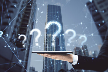 Close up of businessman hand holding cellphone or tablet with glowing polygonal question mark on blurry city background. Ask, confusion and why concept. Double exposure.
