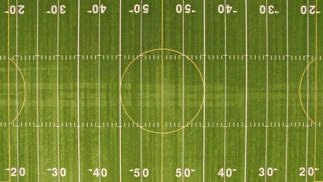 Rugby field grass zooms in view. Football field with green grass and white paint lines and marks. Sports soccer and football with nice green environment. Recreational activity ground.