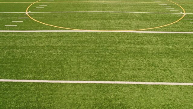 Rugby field top straight down aerial shot zoom out. Empty football playground. Sport stadium green grass and white paint lines and marks for games and activity. Healthy lifestyle.