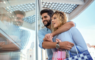 Young couple in shopping. Consumerism, love, dating, lifestyle concept