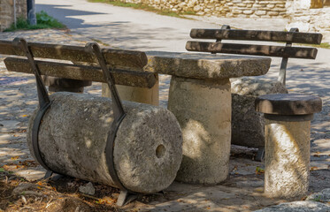 seating and table fashioned from old mill stone pieces in a Spanish village square