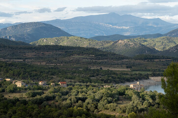 Fototapeta na wymiar view over a village nestled in Parque natural de la Sierra y los Cañones de Guara, towards the Spanish Pyrenees mountains
