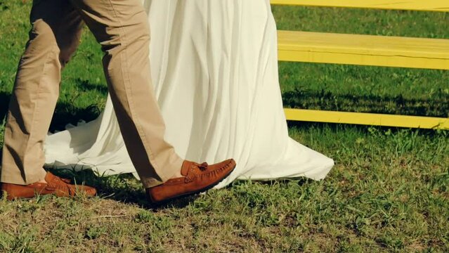 bride and groom walking in the park