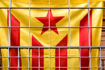 Catalan flag behind bars of a window, Barcelona, Catalonia, Spain, Europe
